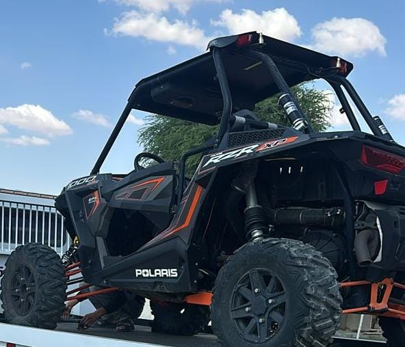 Off-road buggy secured on a flatbed recovery truck in Dubai